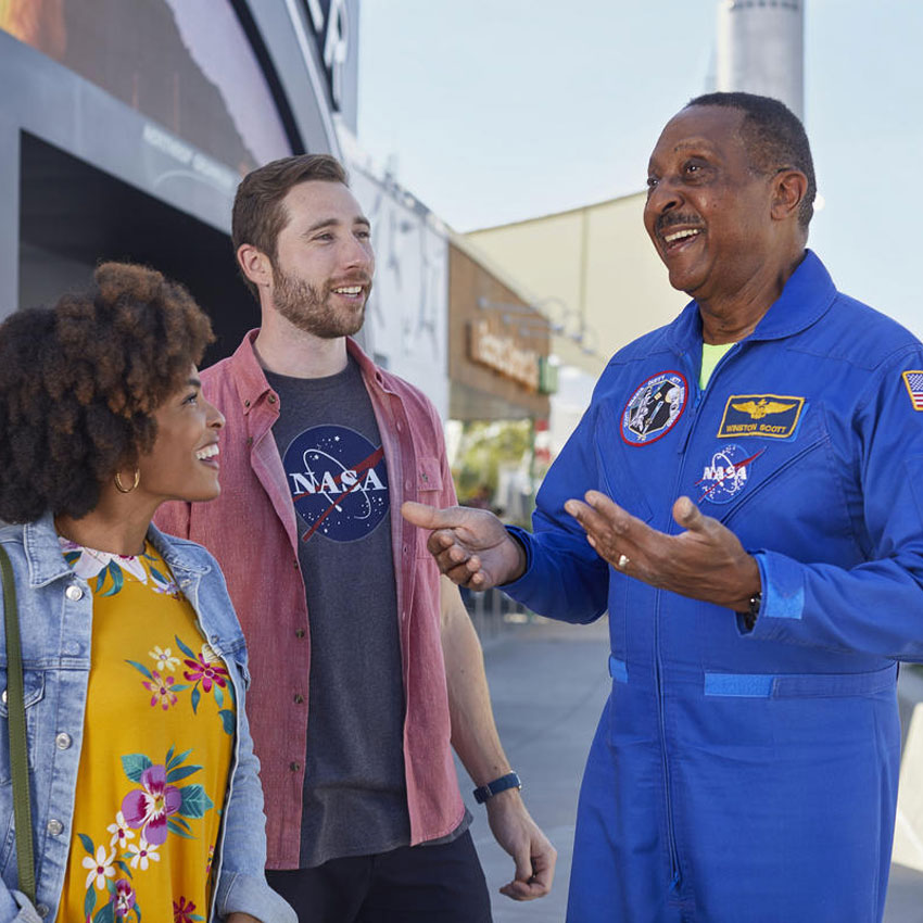 astronaut talking with two people