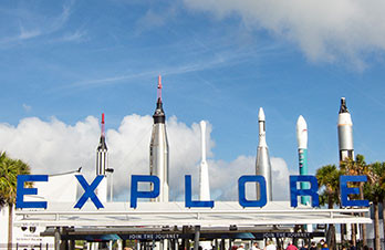 Explore sign below the Rocket Garden at Kennedy Space Center Visitor Complex