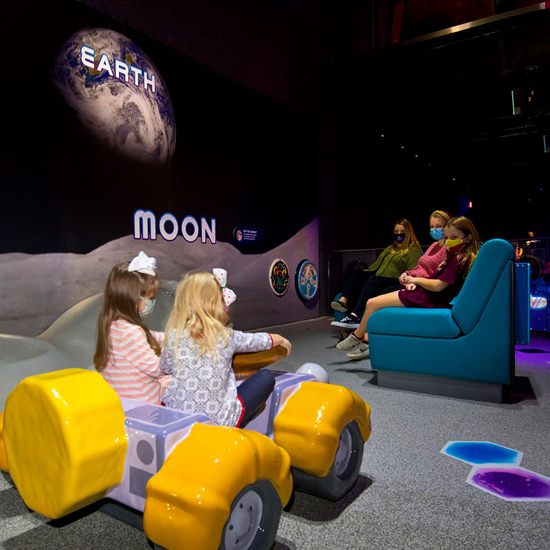 The toddler area in Planet Play at Kennedy Space Center Visitor Complex features a soft play area with tactile play hexagons, a mini lunar rover and other age specific activities.