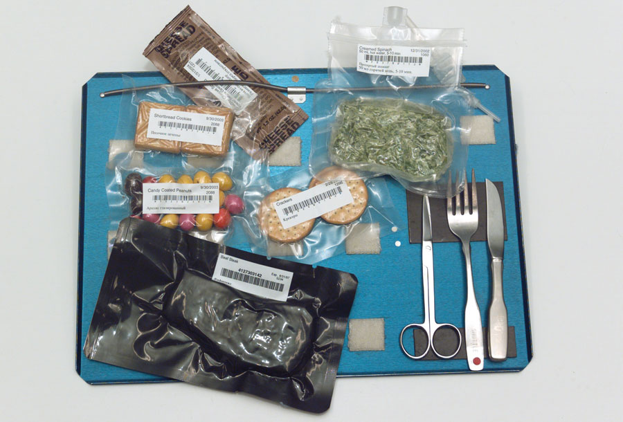 Utensils and bags of food on tray. Photograph taken at Johnson Space Center's Food Tasting lab.