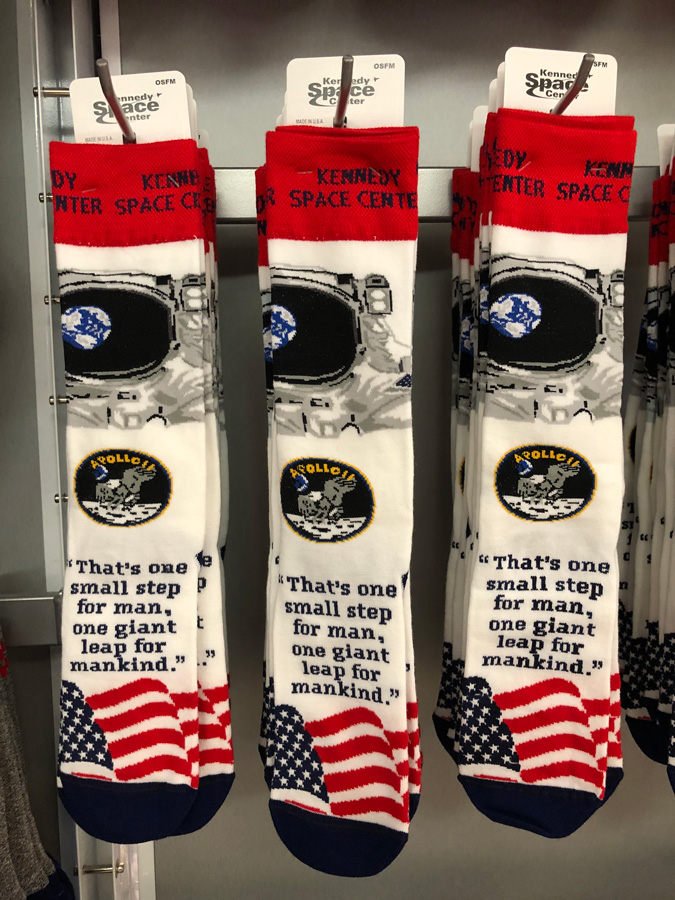 Socks with the america flag, apollo mission path and quote on them