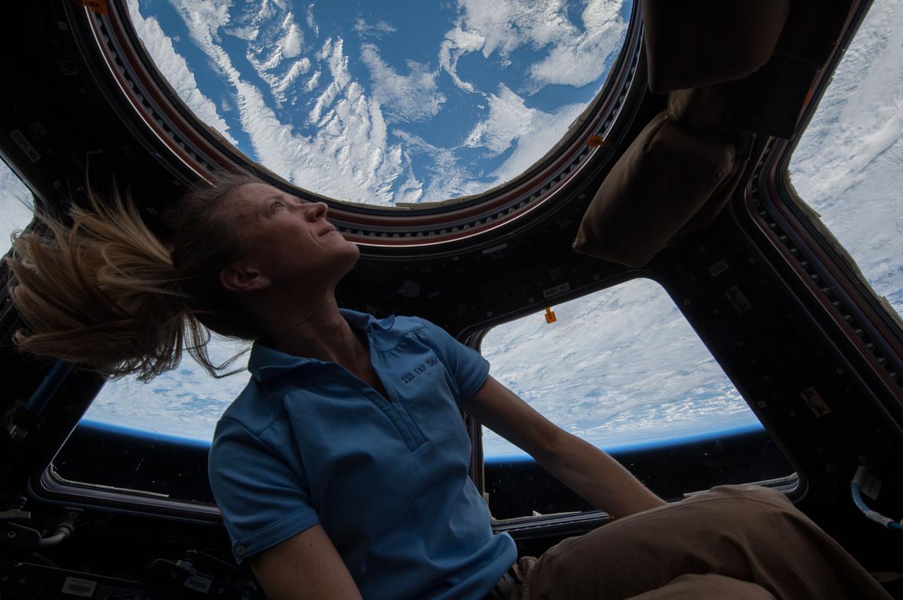 Astronaut Karen Nyberg, Expedition 37 flight engineer, is photographed in front of the windows in the Cupola module .