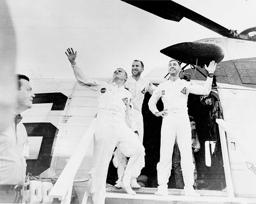 The crew of Apollo 8, the first manned lunar orbit mission, returned to Earth on December 27, 1968, and are pictured waving as they leave the recovery helicopter.