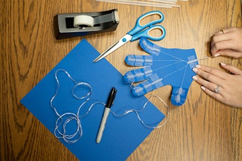 Arts and crafts with blue paper hand.