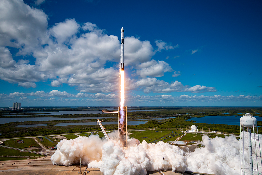SpaceX Falcon 9 lifting off from LC-39 on its way to the International Space Station with the VAB in the background