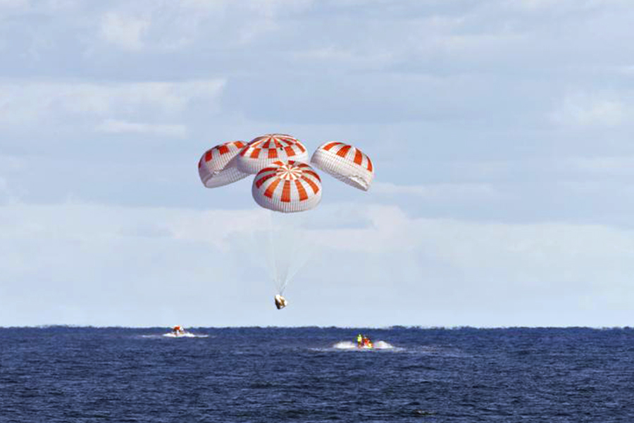 SpaceX’s Crew Dragon is guided by four parachutes as it approaches splashdown in the Atlantic Ocean about 200 miles off Florida’s east coast on March 8, 2019, after returning from the International Space Station on the Demo-1 mission.