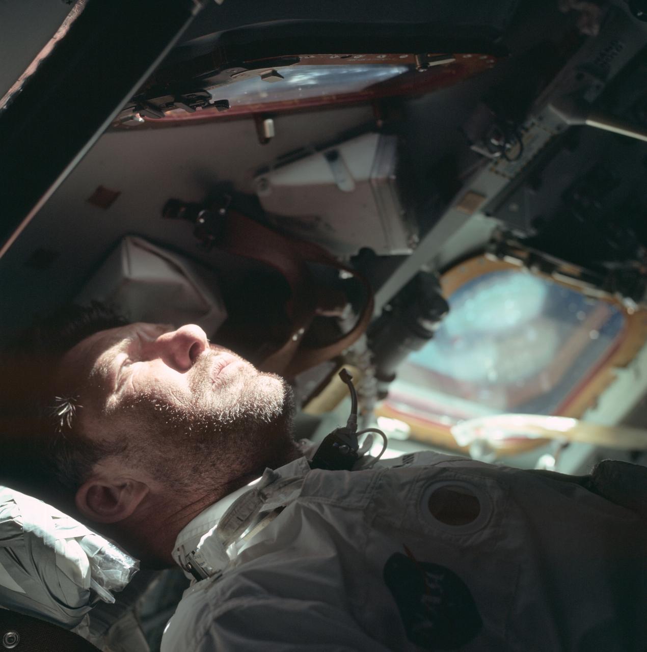 Apollo 7 commander Walter Schirra looks out the rendezvous window on the 9th day of the mission.